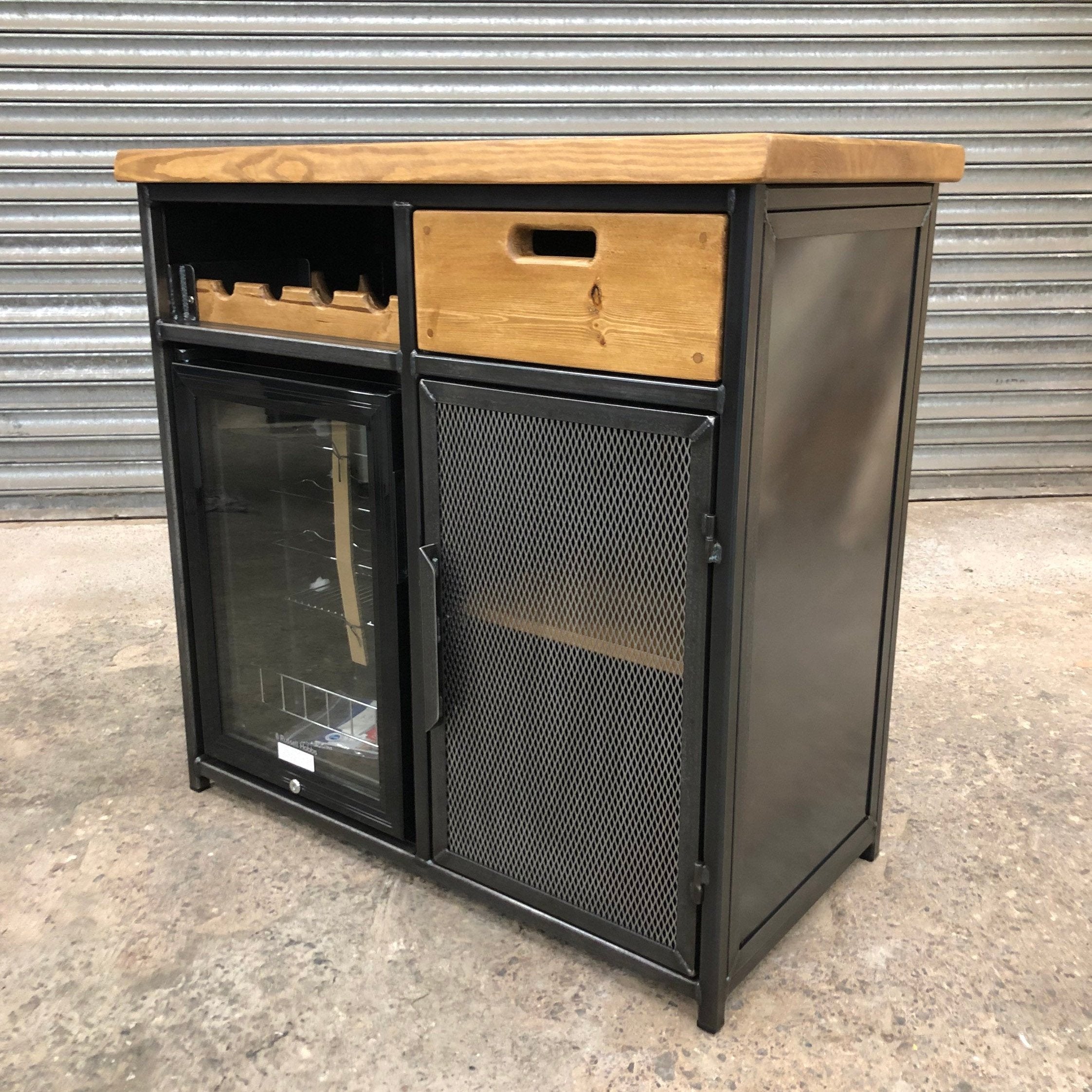 Wine cabinet with steel frame and storage drawer for glassware
