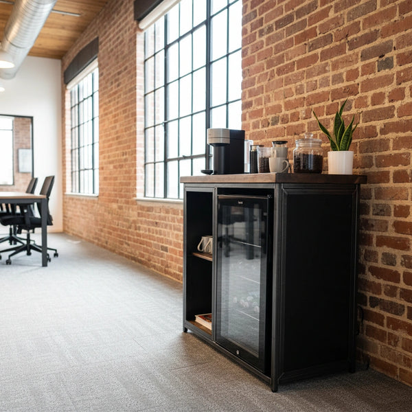 Office Coffee Station Cabinet RSD Furniture - Black refrigerator in an office setting with brick walls and large windows.
