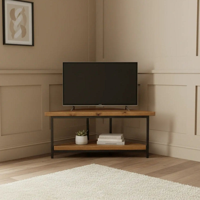 Modern living room with a television on a wooden stand against a beige wall.