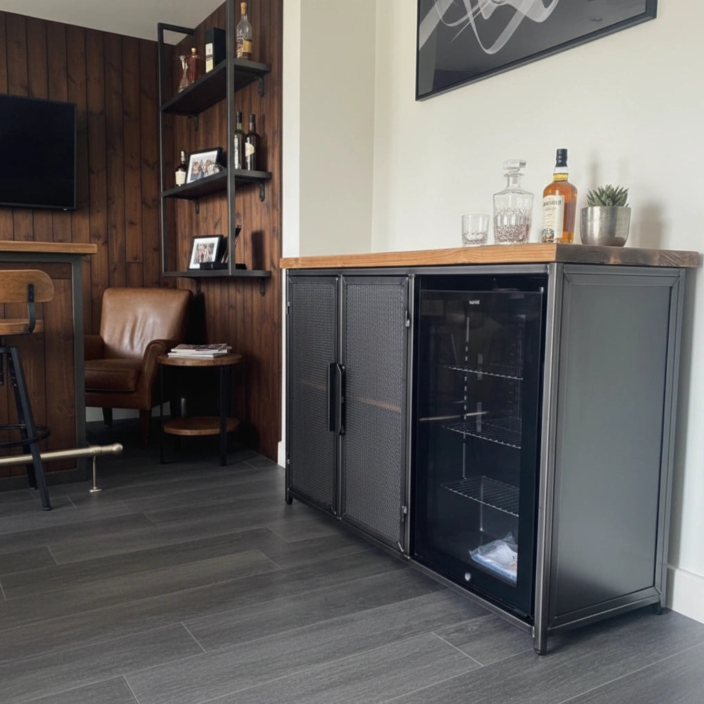 Modern bar area with a black beverage cooler, wooden counter, and leather chairs.