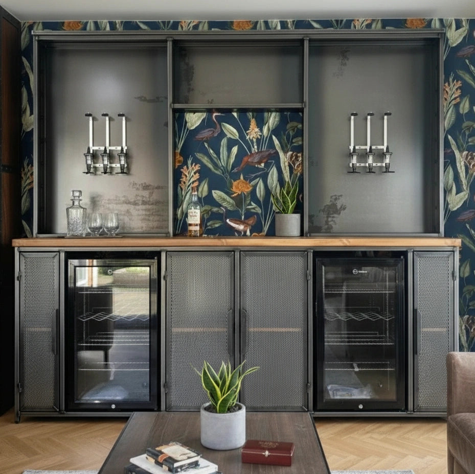 Modern kitchen with dark cabinets, floral wallpaper, and a coffee machine.
